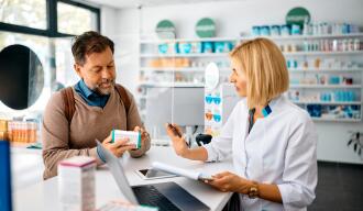 OG_MAN_TALKING_TO_THE_PHARMACIST_WHILE_BUYING_DRUGS_IN_THE_PHARMACY_ISTOCK_2023