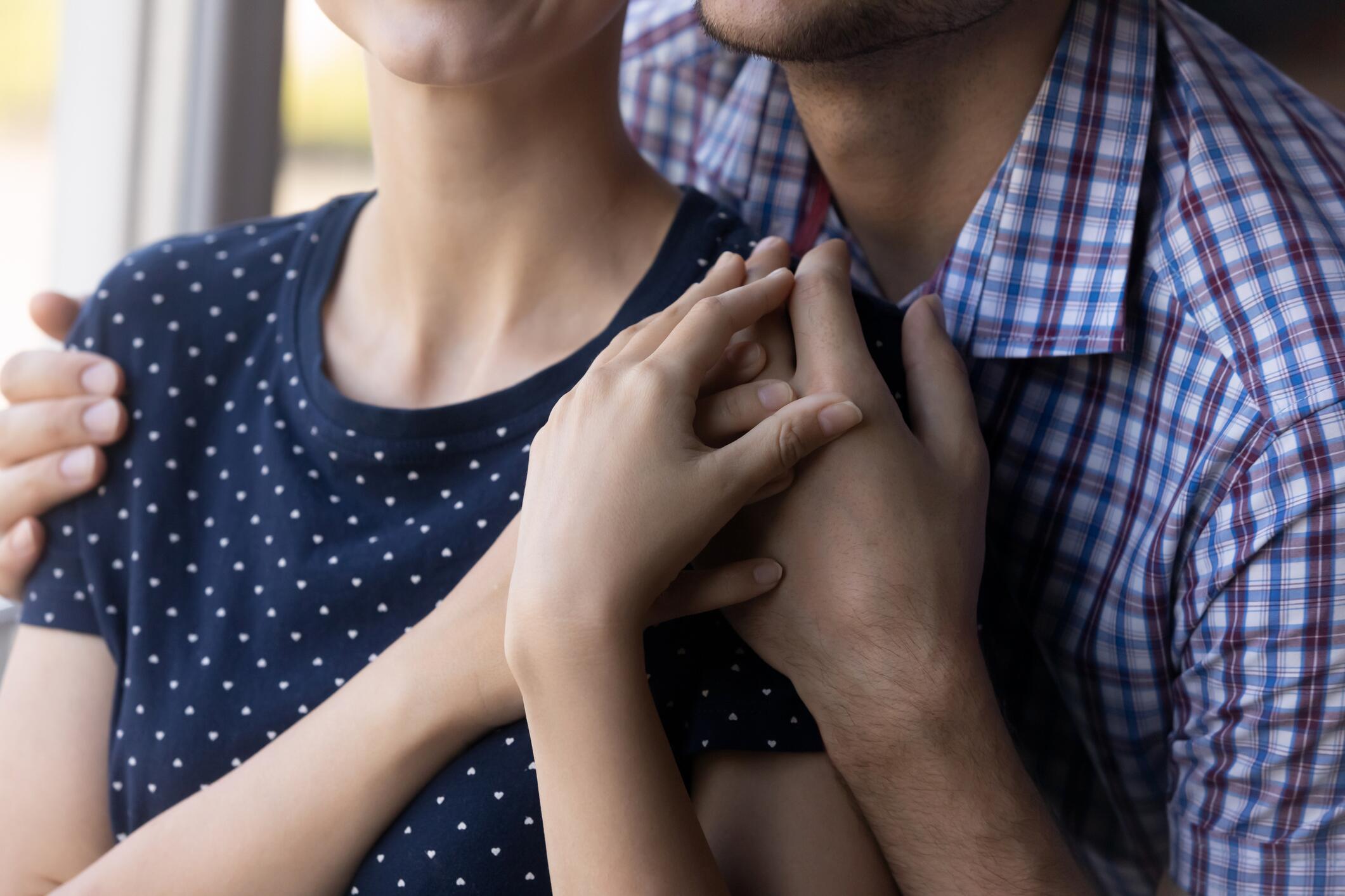 OG_CLOSE_UP_OF_A_YOUNG_COUPLE_EMBRACING_AT_THE_WINDOW_ISTOCK_2023