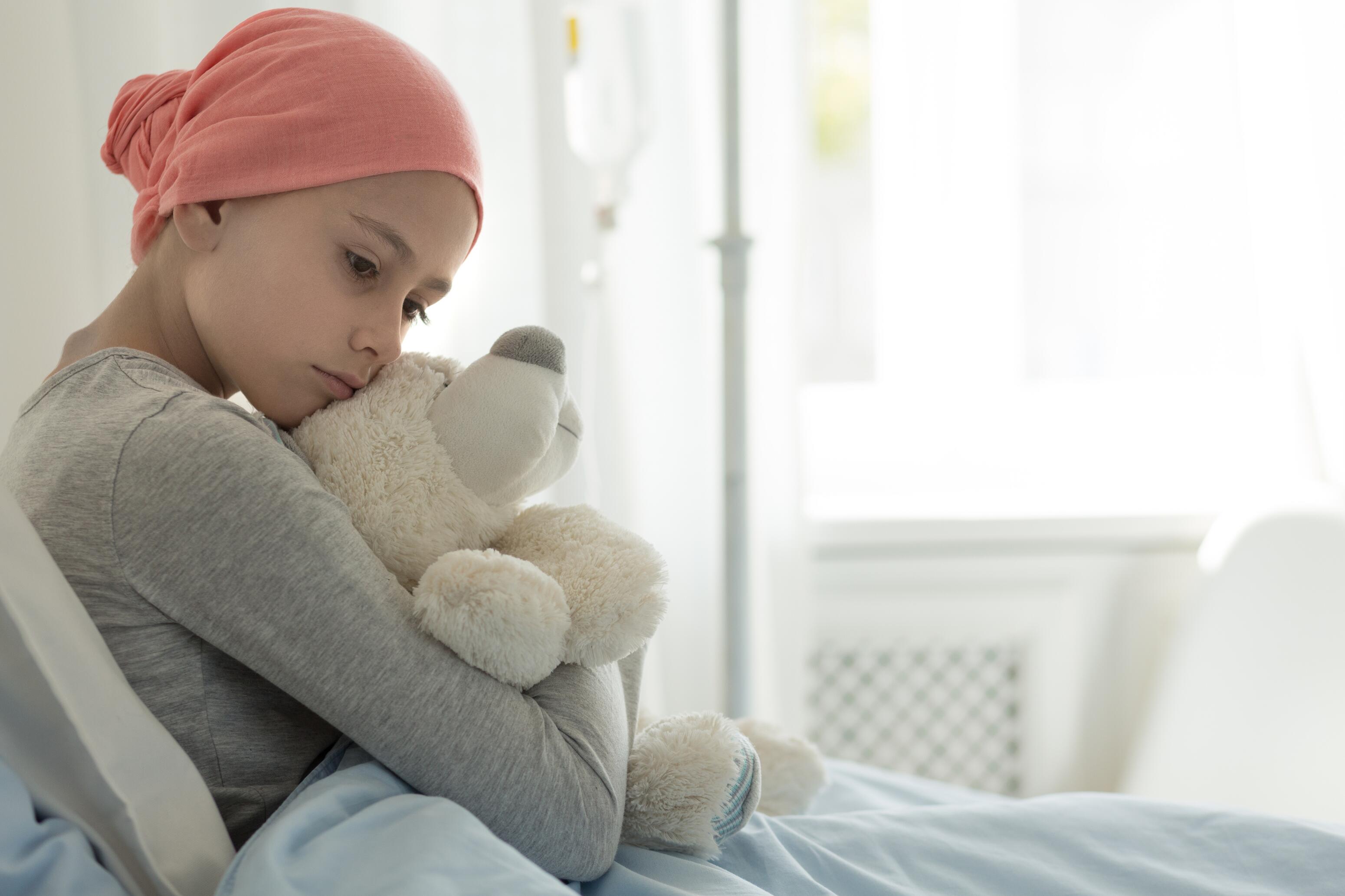 OG_CANCER_GIRL_WEARING_PINK_SCARF_AND_CUDDLING_TEDDY_BEARS_Istock_2025
