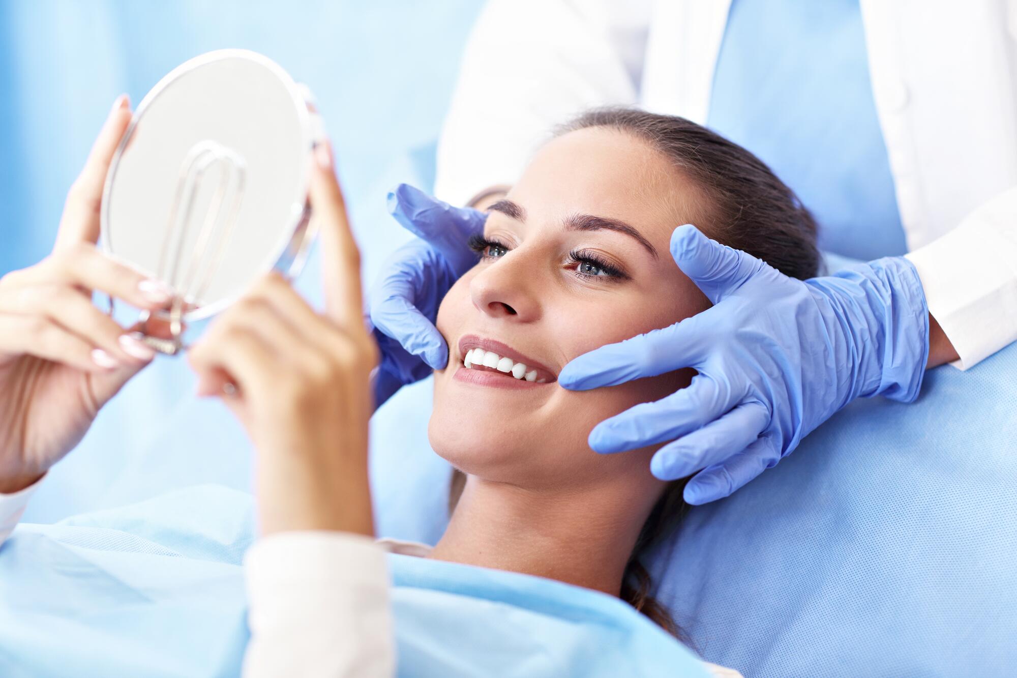 OC_DENTIST_WOMAN_WHITENING_SMILE_SHUTTERSTOCK_1216755457