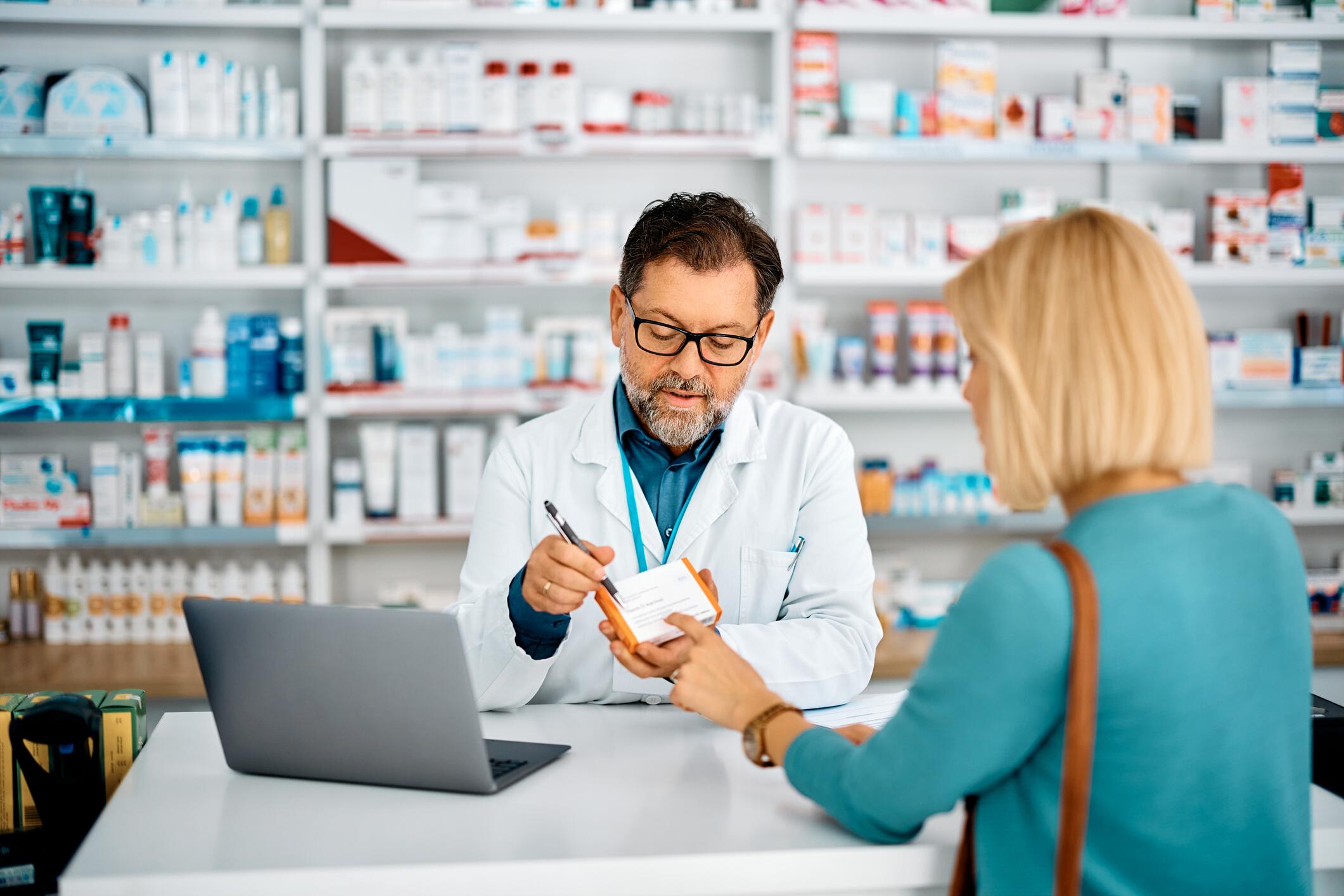OG_MATURE_PHARMACIST_ADVISING_A_CLIENT_WHO_PURCHASES_PRESCRIPTION_DRUGS_AT_A_PHARMACY_ISTOCK_2023
