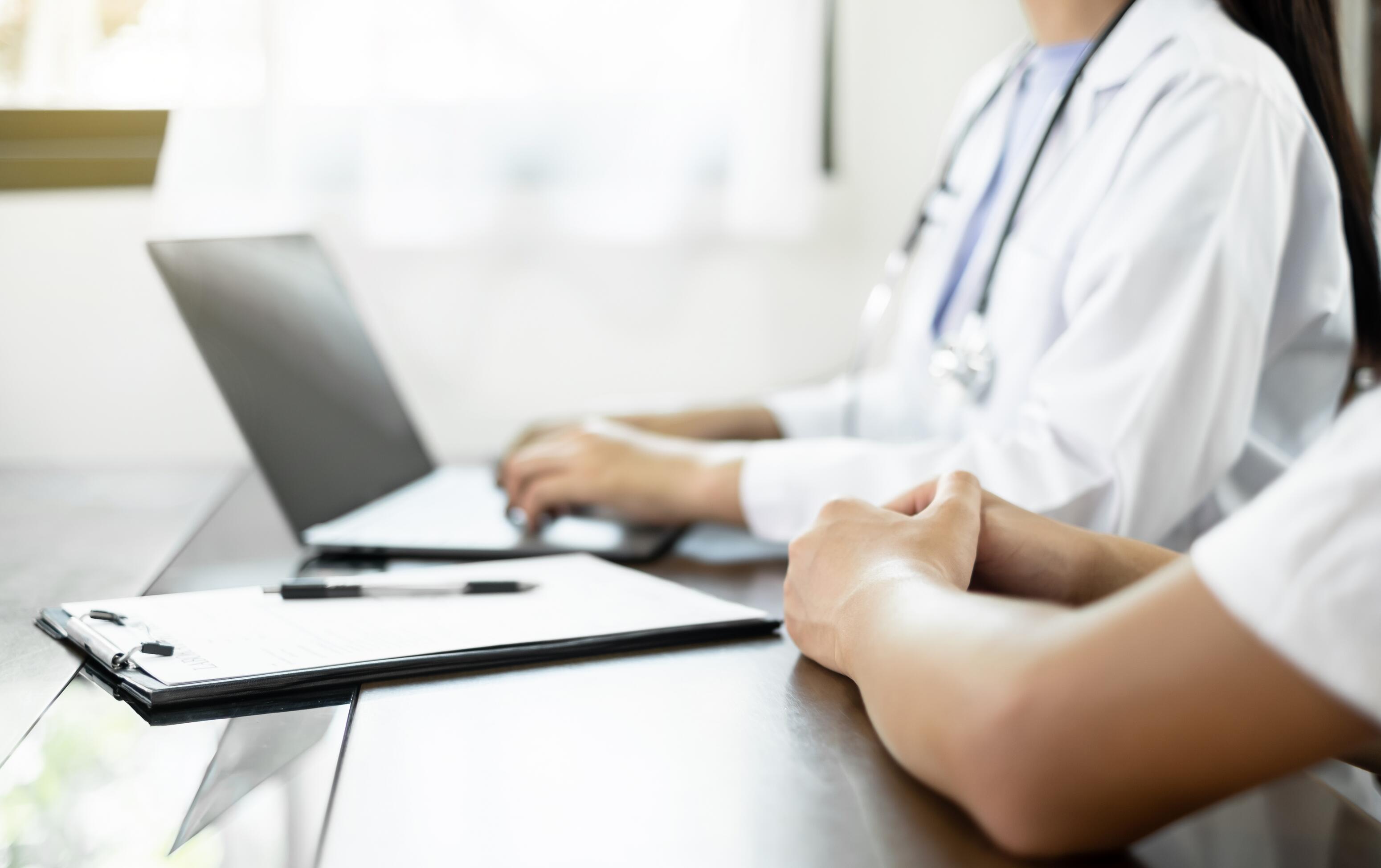 Dermatologist looking at photos of eczema on his computer