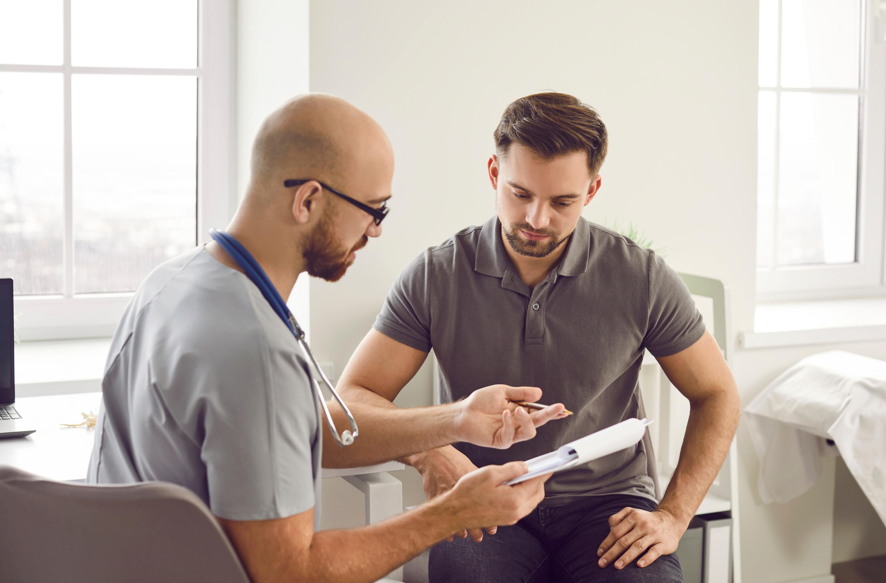 Dermatologist and patient watching the progression of eczema on photos