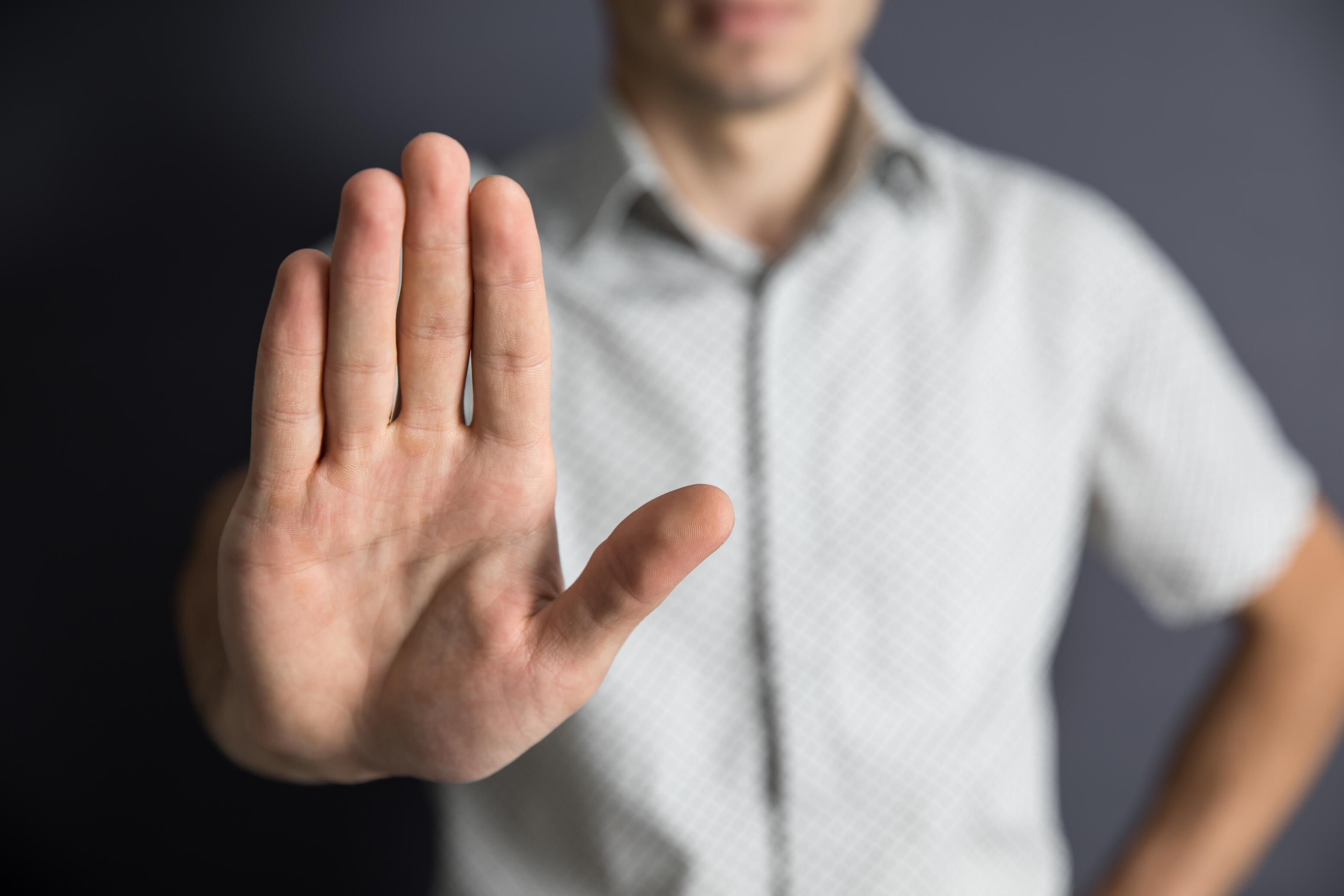 Man waving his hand to stop